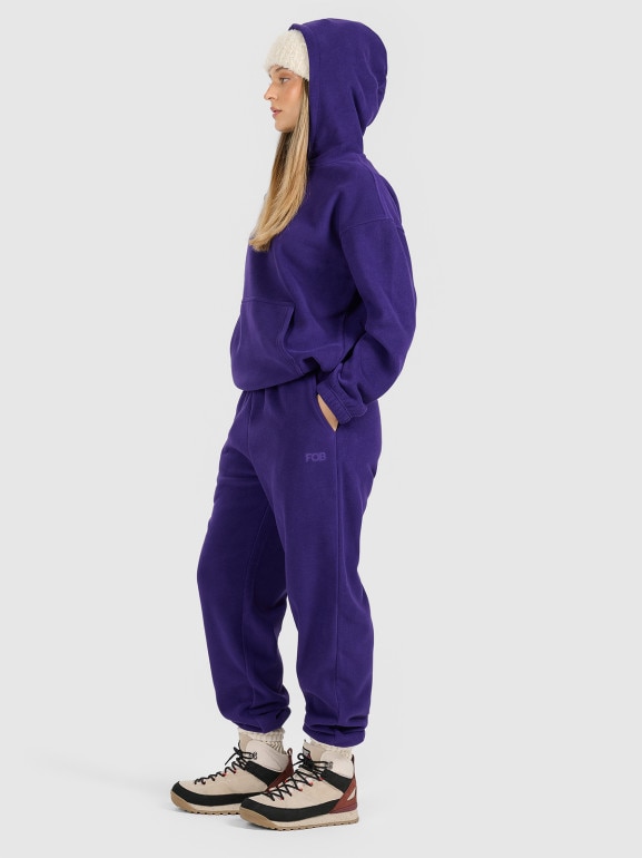 Damskie spodnie dresowe joggery polarowe 4F 4FRAW25TTROF1707 - fioletowe