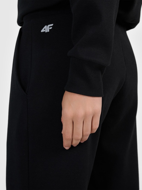 Damskie spodnie dresowe z szerokimi nogawkami 4F 4FRAW25TTROF1919 - czarne