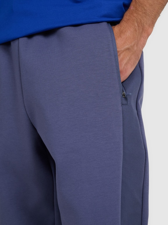Męskie spodnie dresowe joggery 4F 4FWAW25TTROM1252 - granatowe