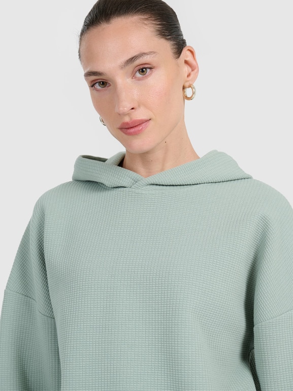 Damska bluza dresowa nierozpinana z kapturem 4F 4FWAW25TSWSF1847 - zielona