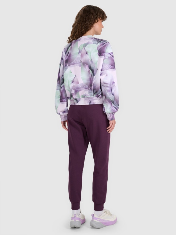 Damskie spodnie dresowe joggery 4F 4FWAW25TTROF1196 - fioletowe