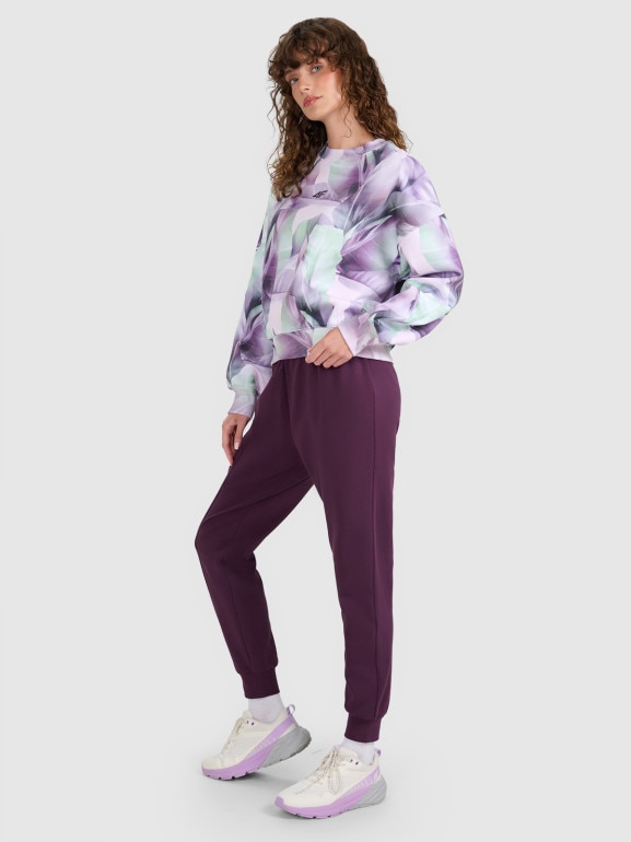 Damskie spodnie dresowe joggery 4F 4FWAW25TTROF1196 - fioletowe