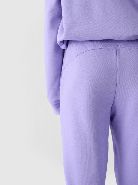 Dziewczęce spodnie dresowe joggery 4F 4FJWMM00TTROF0829-27M - fioletowe