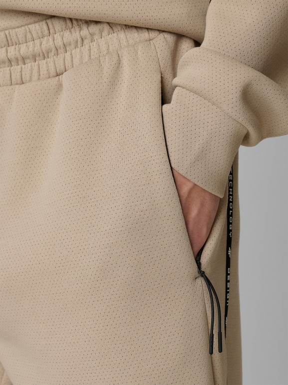 Męskie spodnie dresowe joggery 4F 4FWSS26TTROM1443 - beżowe