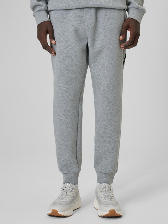 Męskie spodnie dresowe joggery 4F 4FWSS26TTROM1443 - szare
