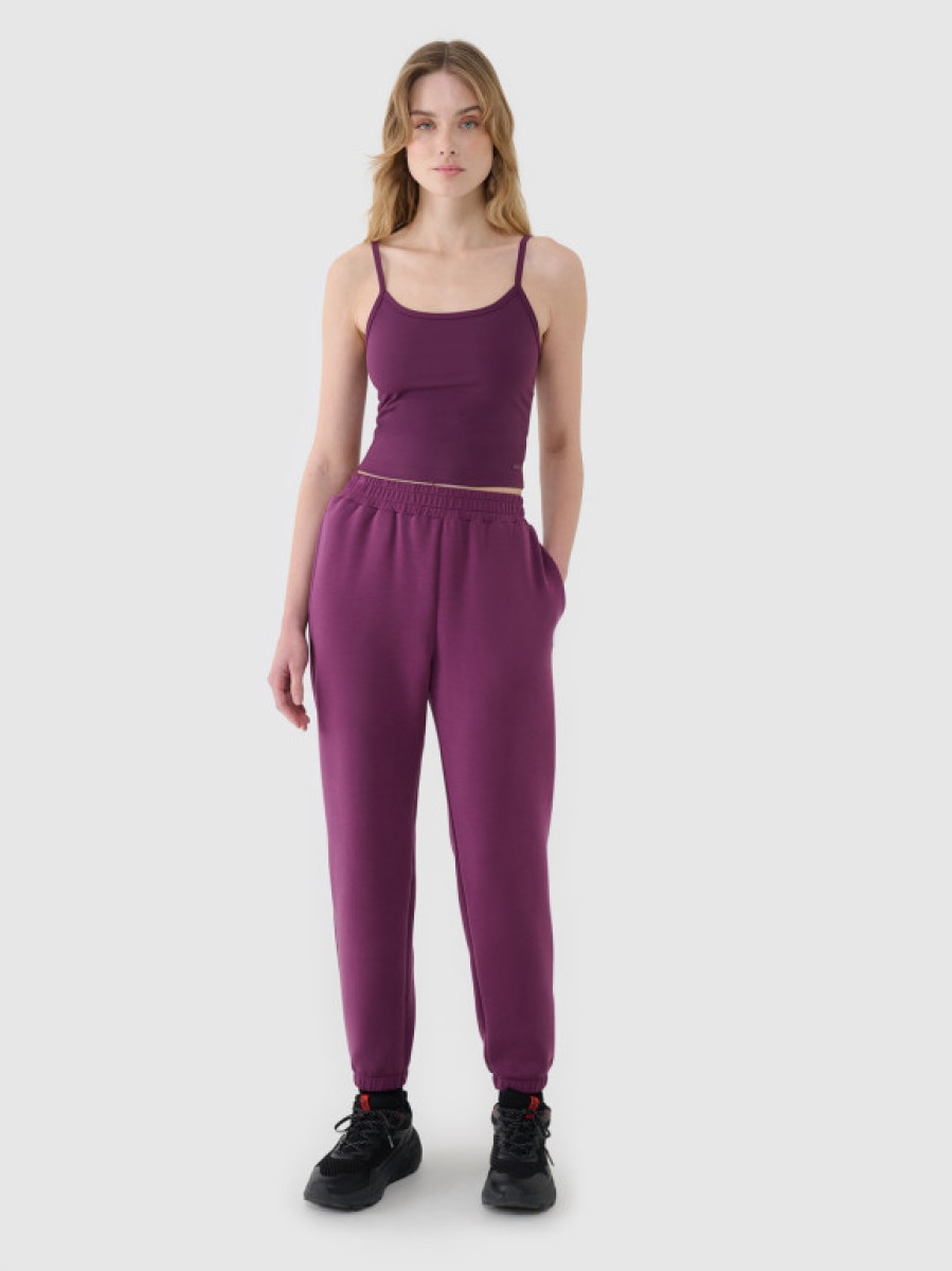 Damskie spodnie dresowe joggery 4F 4FWSS25TTROF1010 - fioletowe