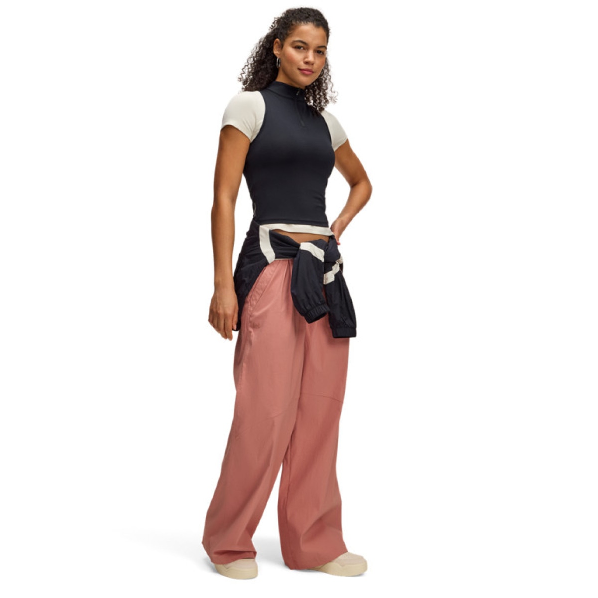 Damskie spodnie casual tkaninowe Under Armour UA Unstoppable Wvn Parachute - pomarańczowe