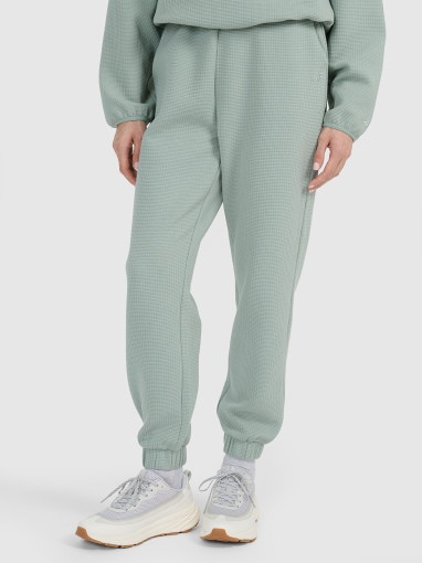 Damskie spodnie dresowe 4F 4FWAW25TTROF1184 - zielone