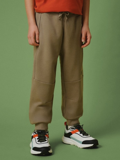 Chłopięce spodnie dresowe joggery 4F 4FJRSS26TTROM1995 - beżowe