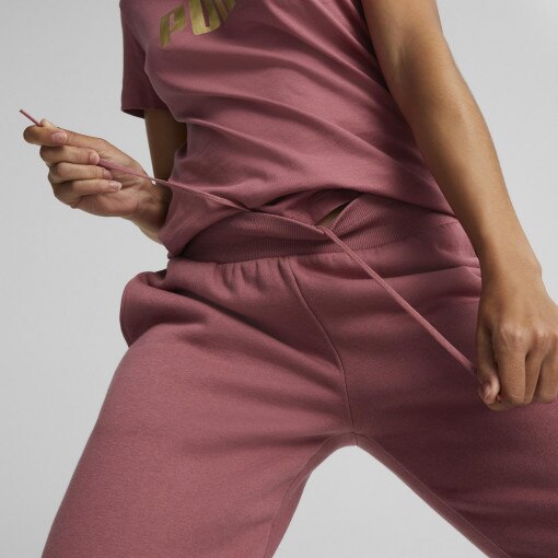Damskie spodnie dresowe PUMA Essentials+ Metallic - różowe