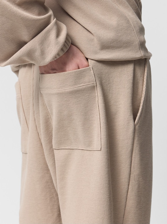 Męskie spodnie dzianinowe Outhorn OTHWSS24TTROM1050 - beżowe