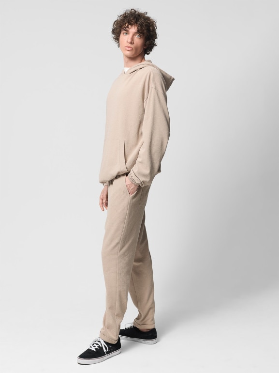 Męskie spodnie dzianinowe Outhorn OTHWSS24TTROM1050 - beżowe