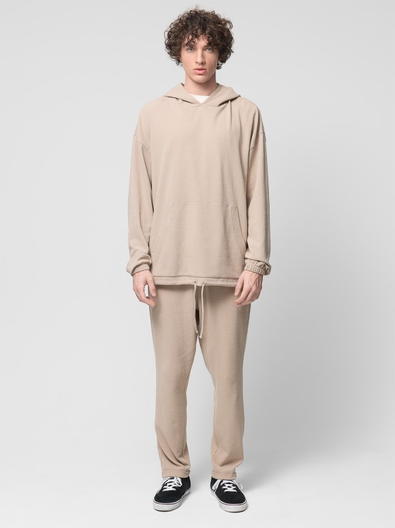 Męskie spodnie dzianinowe Outhorn OTHWSS24TTROM1050 - beżowe