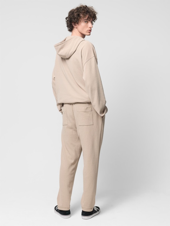 Męskie spodnie dzianinowe Outhorn OTHWSS24TTROM1050 - beżowe